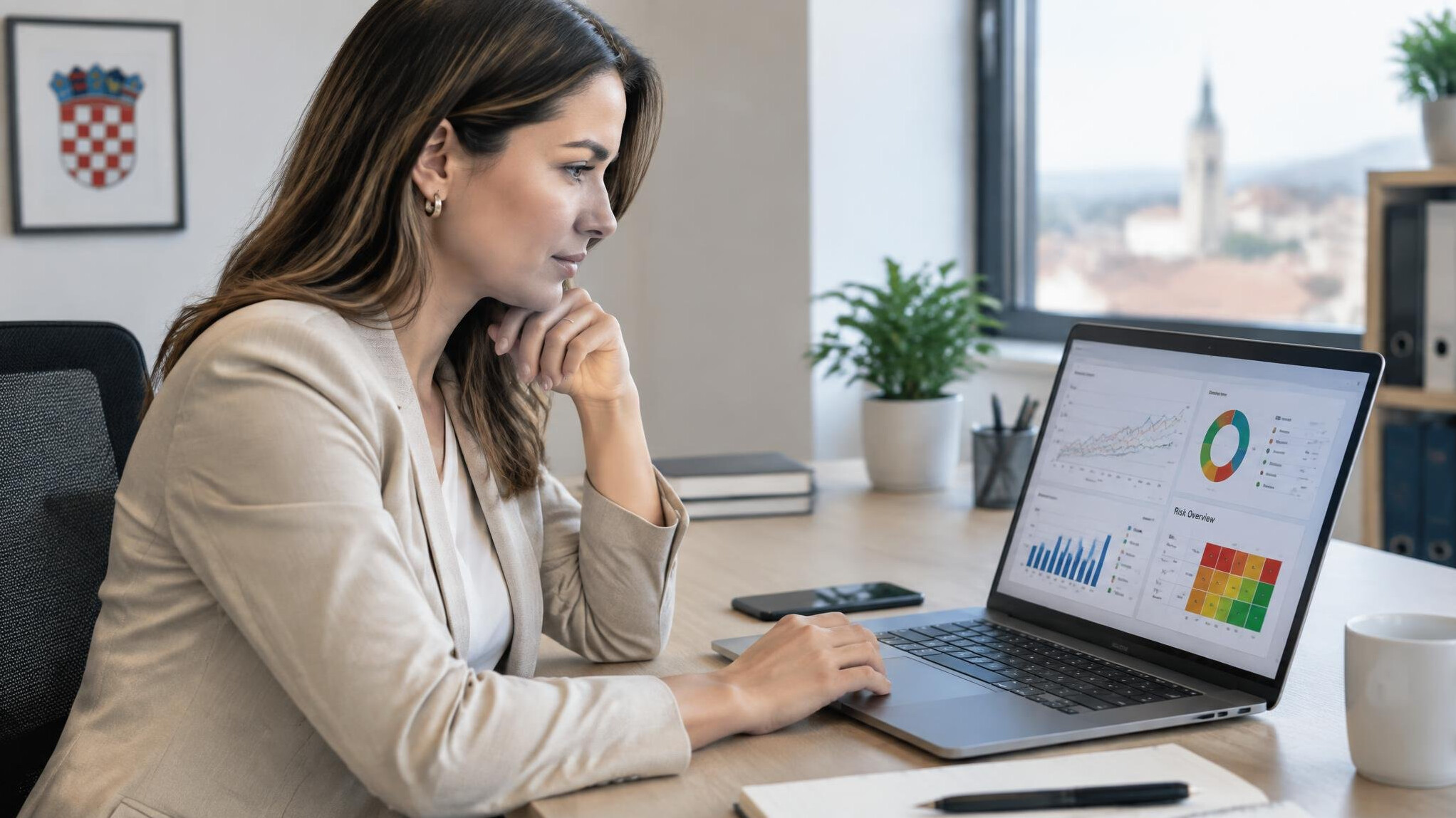 Insurance analyst reviewing digital charts on a laptop