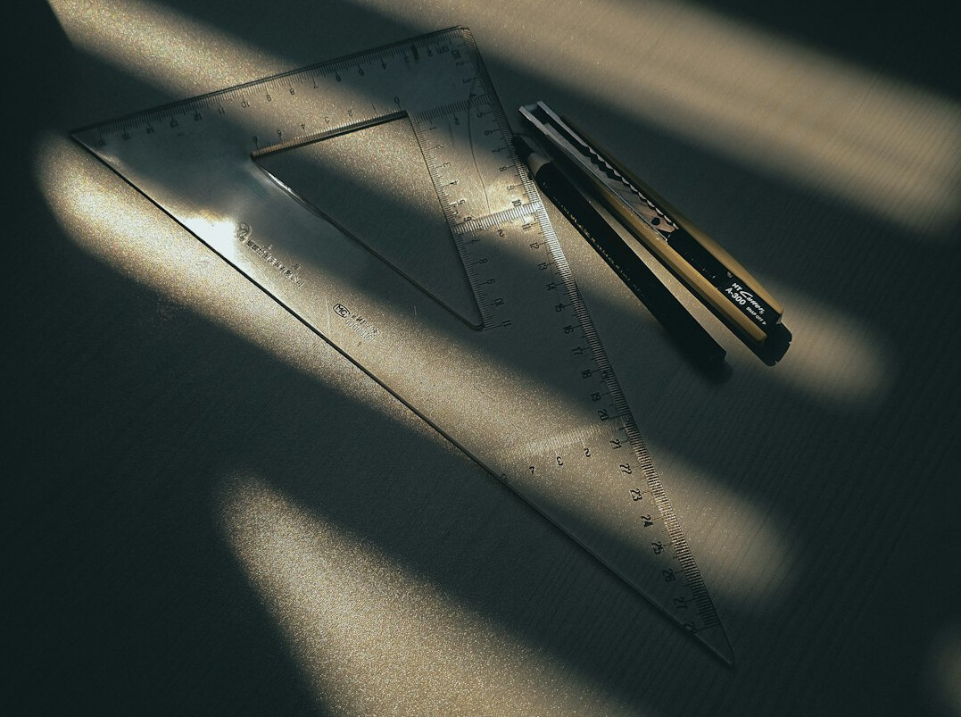 Stack of printed documents and a pen on a desk